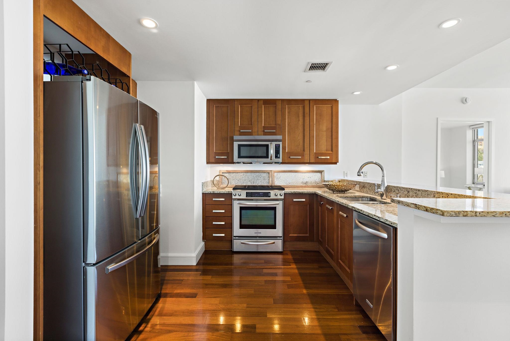 8100 River Road, Unit 1013 North Bergen, NJ 07047 - Photo 6 of 19 a kitchen with stainless steel appliances granite countertop a refrigerator and a stove top oven