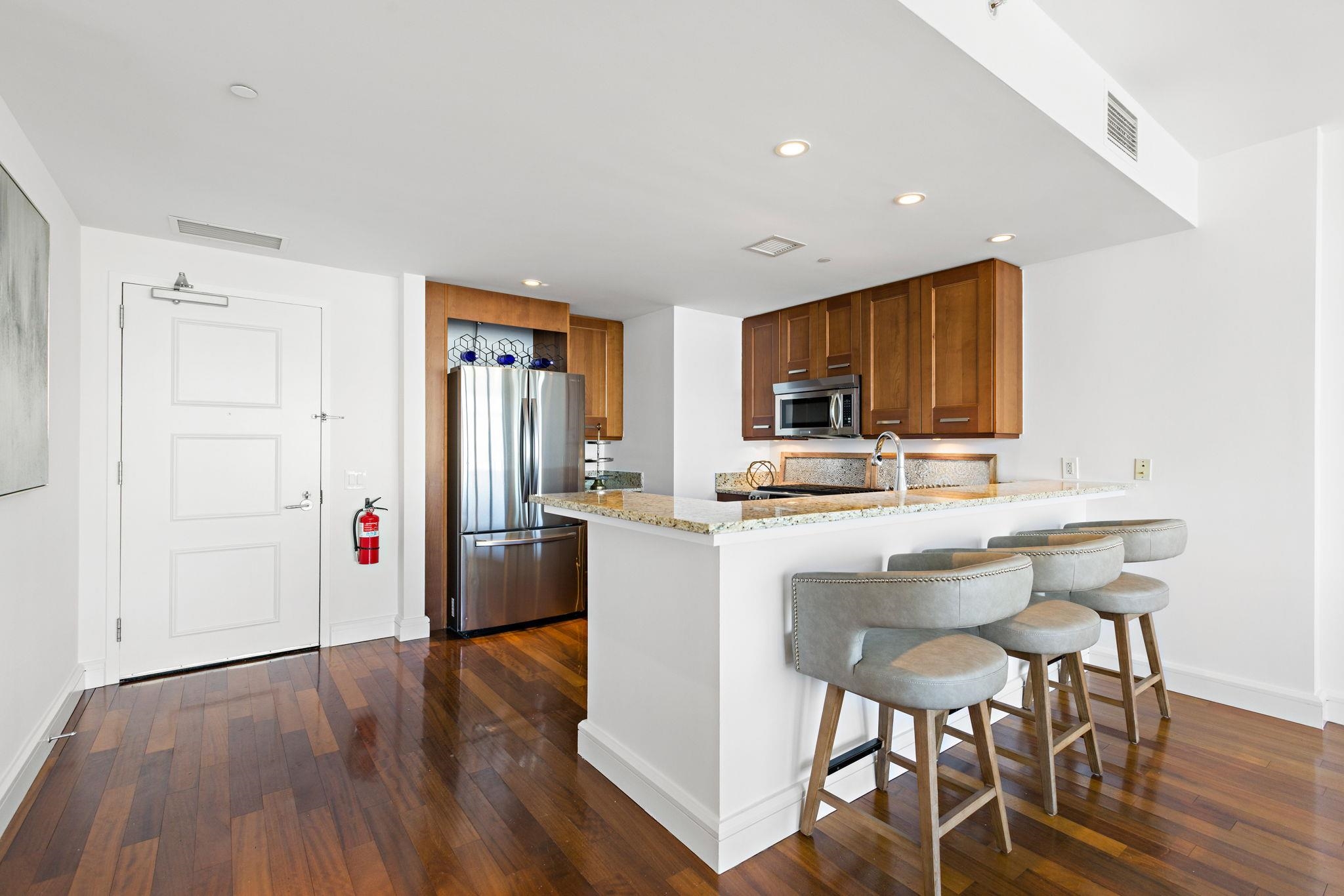8100 River Road, Unit 1013 North Bergen, NJ 07047 - Photo 7 of 19 a kitchen with stainless steel appliances a refrigerator and a stove top oven