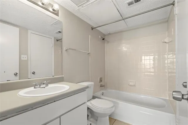 a bathroom with a sink toilet tub and shower