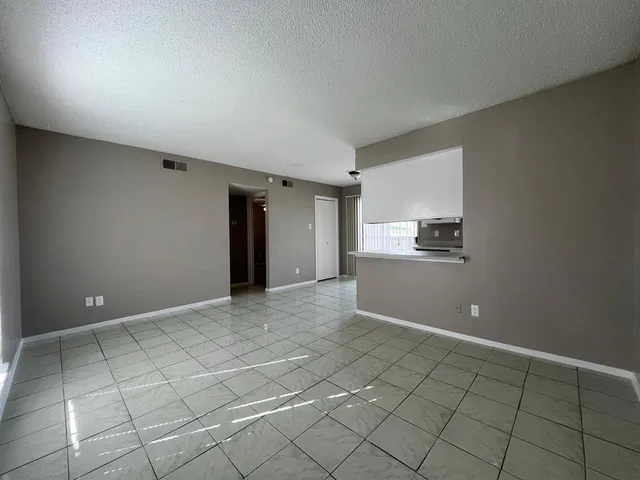 a view of kitchen with refrigerator and cabinets