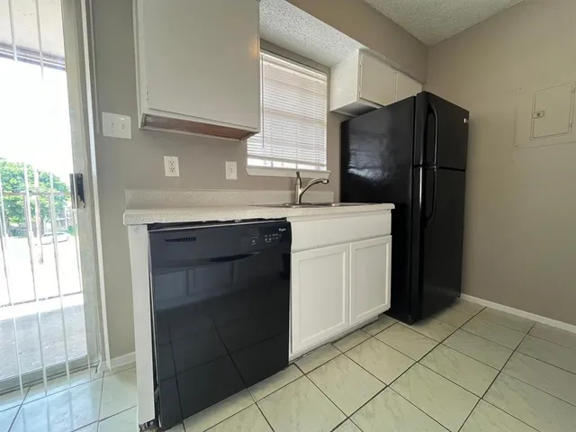 a kitchen with a refrigerator and a sink