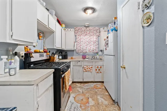 a kitchen with a refrigerator and a sink