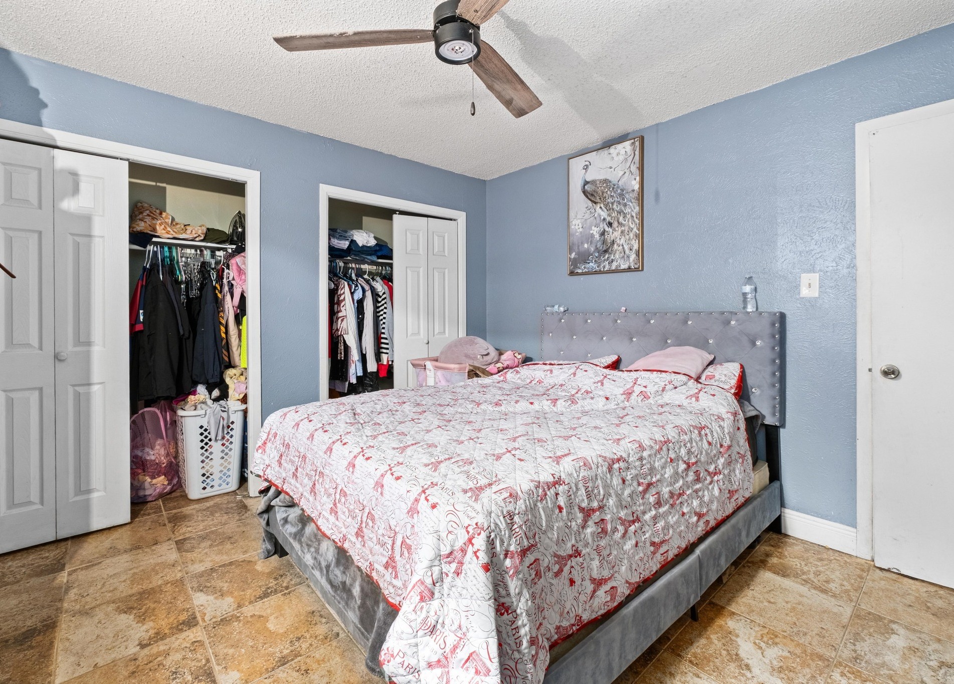 8203 Colony Loop Drive Austin, TX 78724 - Photo 5 of 11 a bedroom with a large bed and a chandelier