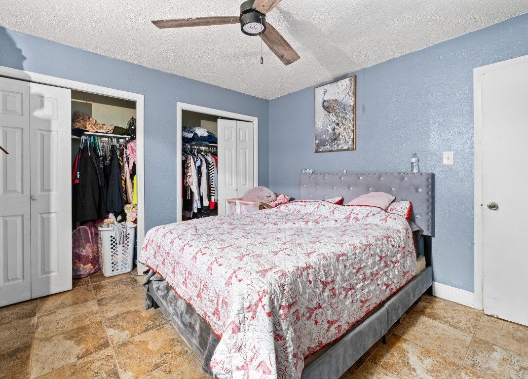 8203 Colony Loop Drive Austin, TX 78724 - Photo 5 of 11 a bedroom with a large bed and a chandelier