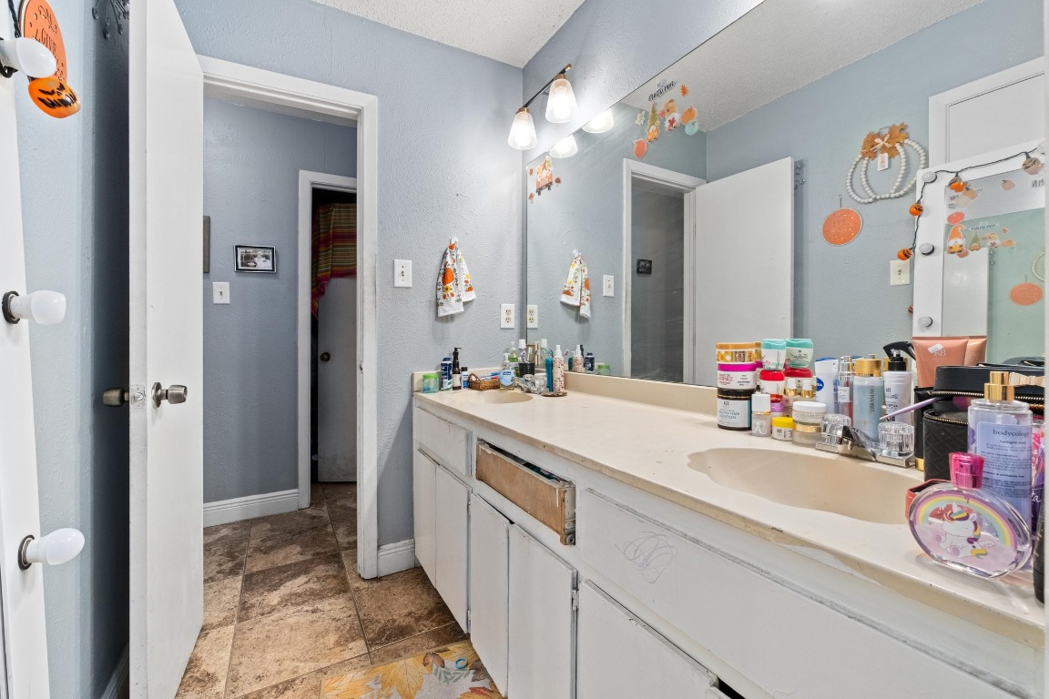 8203 Colony Loop Drive Austin, TX 78724 - Photo 6 of 11 a bathroom with a sink and a mirror