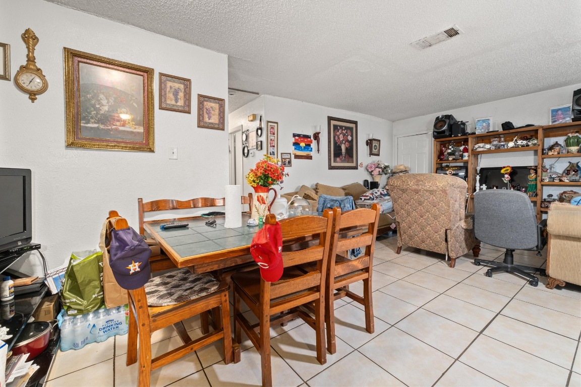8203 Colony Loop Drive Austin, TX 78724 - Photo 7 of 11 a dining room with furniture and a flat screen tv