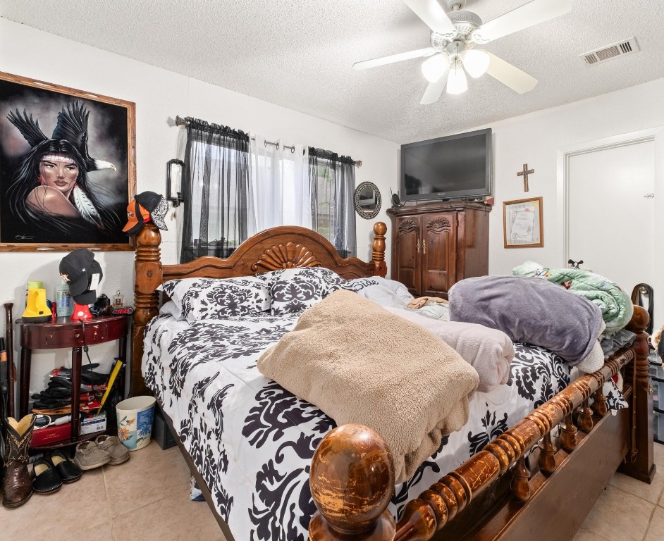 8203 Colony Loop Drive Austin, TX 78724 - Photo 8 of 11 a bedroom with two beds and a chandelier