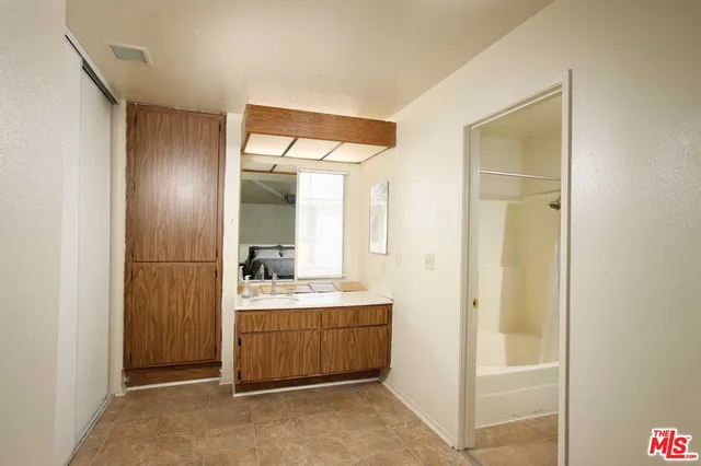 a bathroom with a double vanity sink and mirror