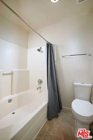 a bathroom with a bathtub and a toilet
