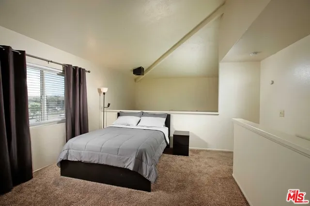 a bedroom with a bed and a night stand