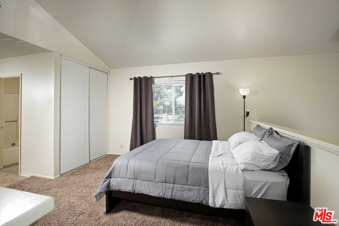 936 East Fairway Drive, Unit 23 Colton, CA 92324 - Photo 14 of 32 a bedroom with a bed and window