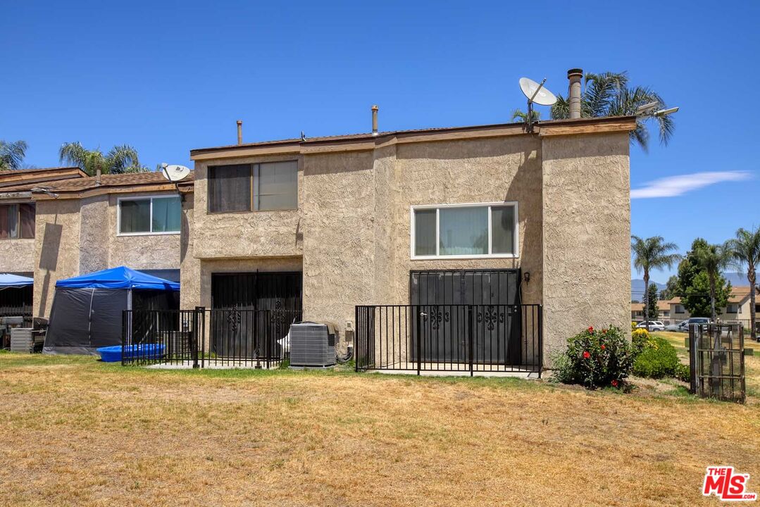 936 East Fairway Drive, Unit 23 Colton, CA 92324 - Photo 19 of 32 a front view of a house with a yard