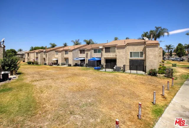 a backyard of a house with a small yard and outdoor seating
