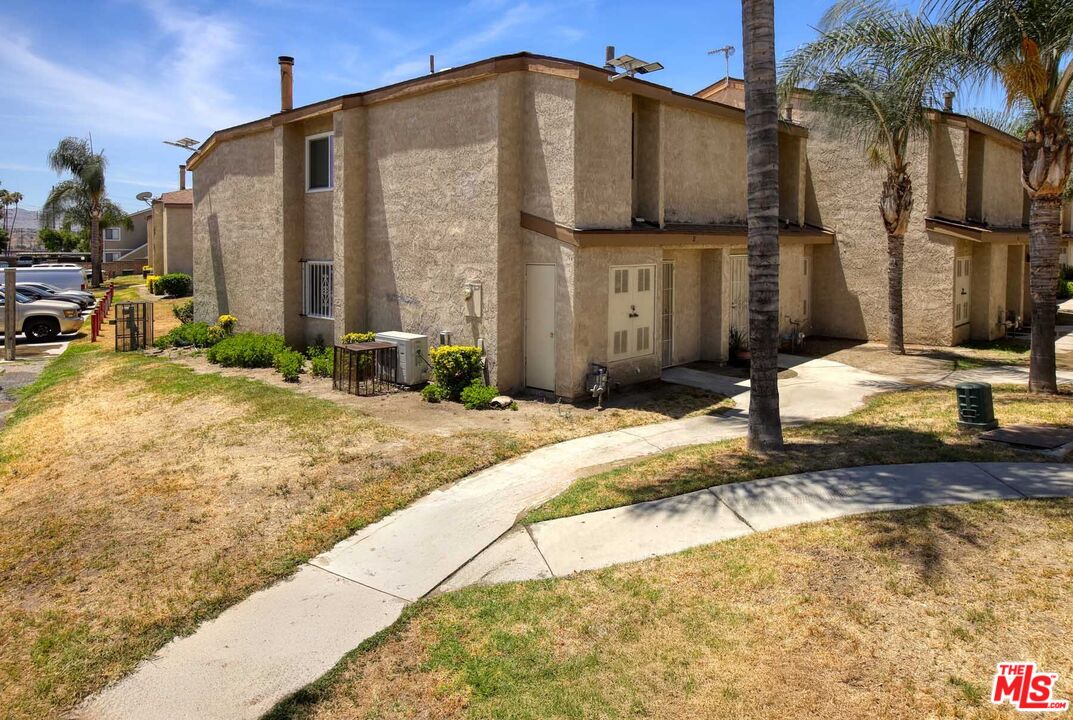 936 East Fairway Drive, Unit 23 Colton, CA 92324 - Photo 28 of 32 a front view of a house with a yard
