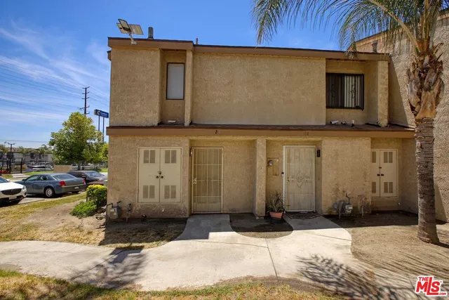 a view of a house with swimming pool and sitting area