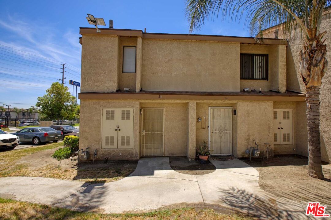 936 East Fairway Drive, Unit 23 Colton, CA 92324 - Photo 30 of 32 a front view of a house with a yard