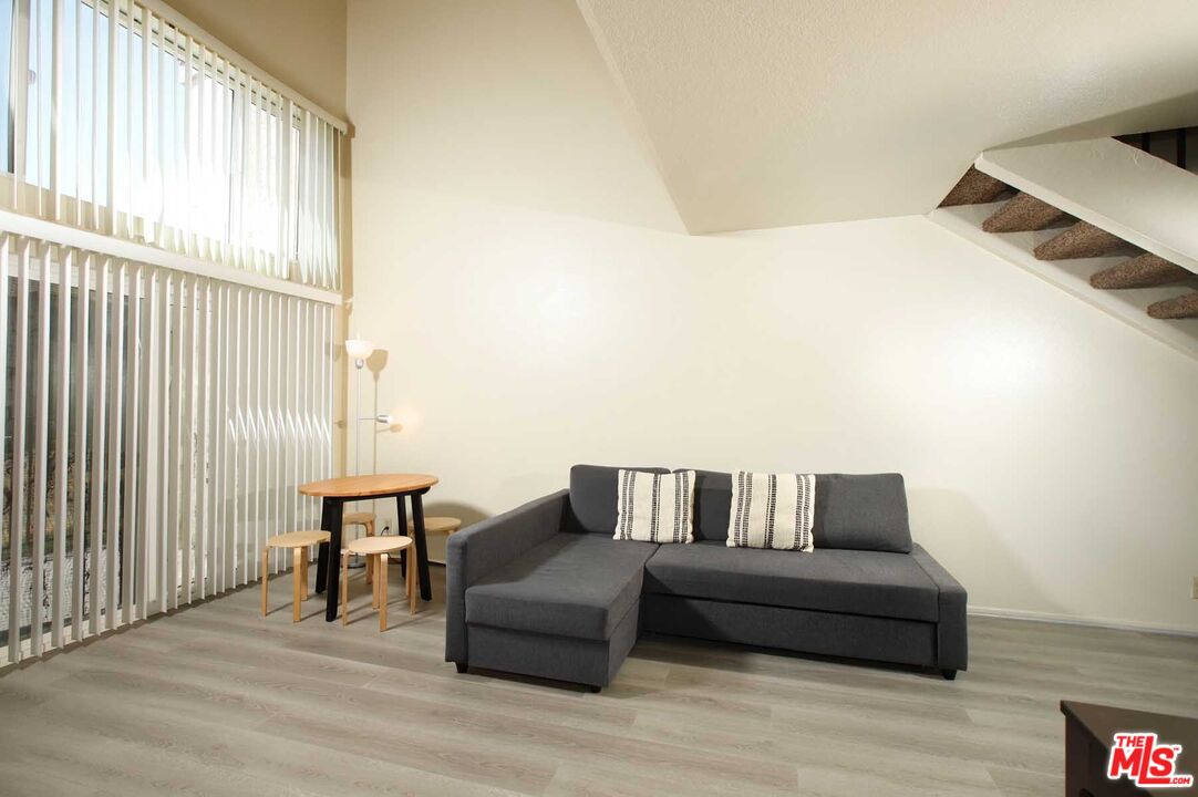 936 East Fairway Drive, Unit 23 Colton, CA 92324 - Photo 3 of 32 a living room with furniture and a floor to ceiling window