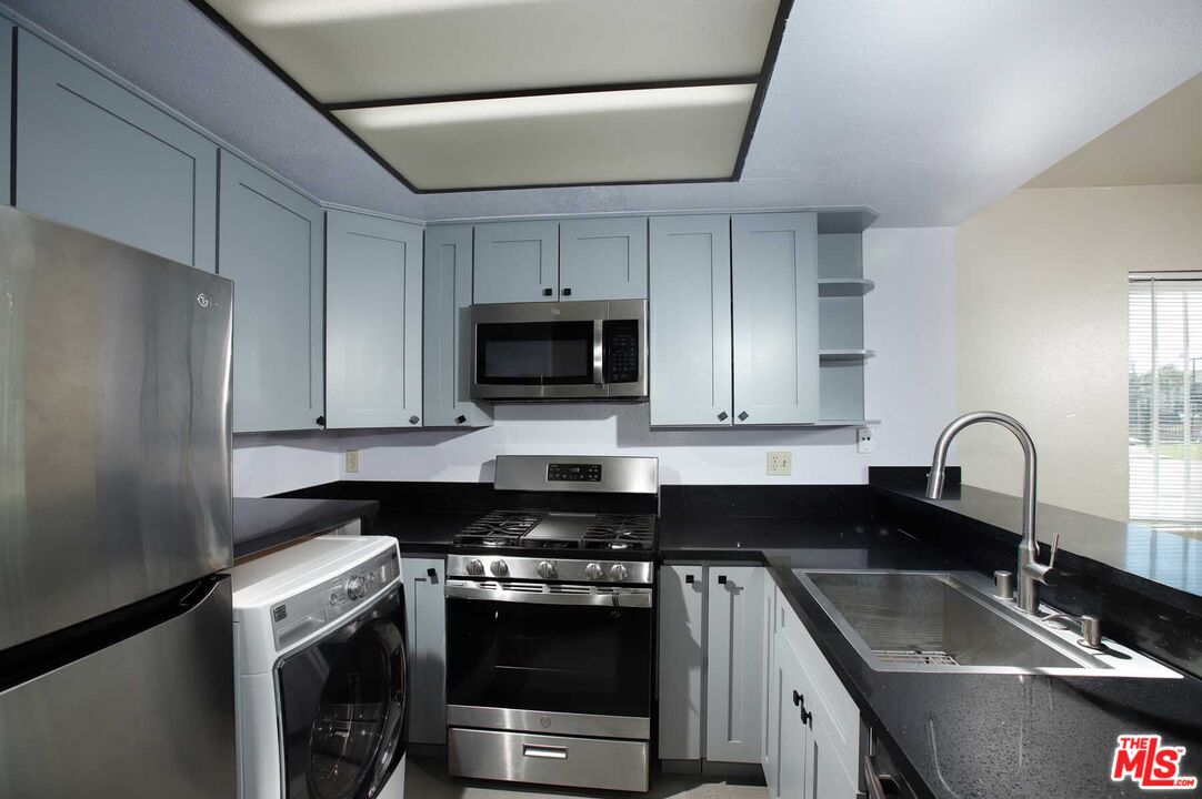 936 East Fairway Drive, Unit 23 Colton, CA 92324 - Photo 8 of 32 a kitchen with a sink stove and microwave