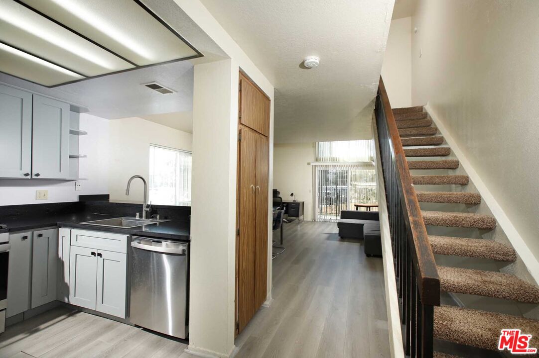 936 East Fairway Drive, Unit 23 Colton, CA 92324 - Photo 9 of 32 a kitchen with white cabinets and appliances