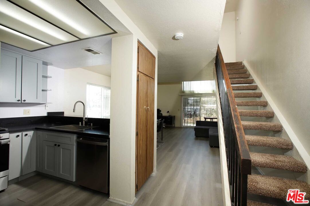 936 East Fairway Drive, Unit 23 Colton, CA 92324 - Photo 10 of 32 a view of entryway and kitchen with wooden floor