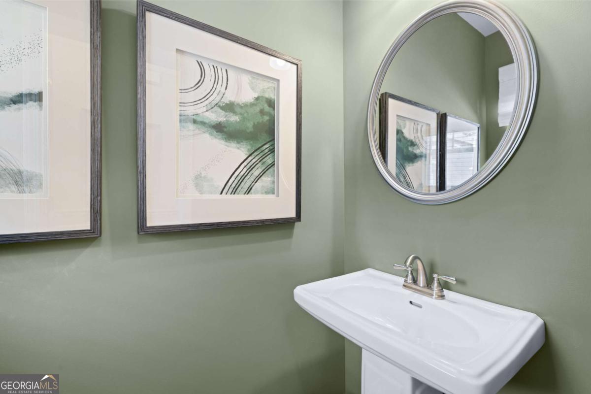 10429 Trellis Lane, Unit (LOT 29) Hampton, GA 30228 - Photo 12 of 27 a bathroom with a sink and a mirror