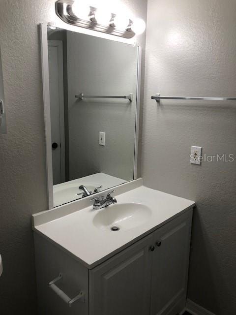 957 Salt Pond Place, Unit 101 Altamonte Springs, FL 32714 - Photo 18 of 20 a bathroom with a sink and mirror