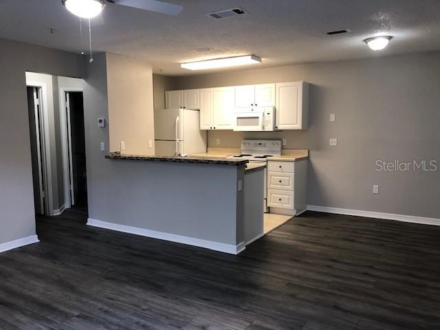 957 Salt Pond Place, Unit 101 Altamonte Springs, FL 32714 - Photo 5 of 20 a kitchen with stainless steel appliances granite countertop a sink stove and refrigerator