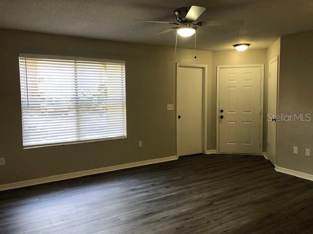 957 Salt Pond Place, Unit 101 Altamonte Springs, FL 32714 - Photo 6 of 20 a view of an empty room with wooden floor and a window
