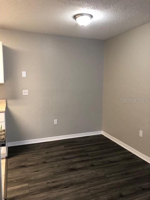 957 Salt Pond Place, Unit 101 Altamonte Springs, FL 32714 - Photo 9 of 20 a view of an empty room with wooden floor