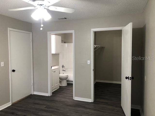957 Salt Pond Place, Unit 101 Altamonte Springs, FL 32714 - Photo 10 of 20 a view of a bathroom with a hardwood floor and a ceiling fan