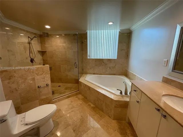 a bathroom with a tub a toilet and a shower