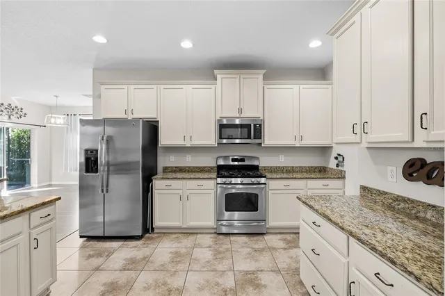a bedroom with a bed and a chandelier fan