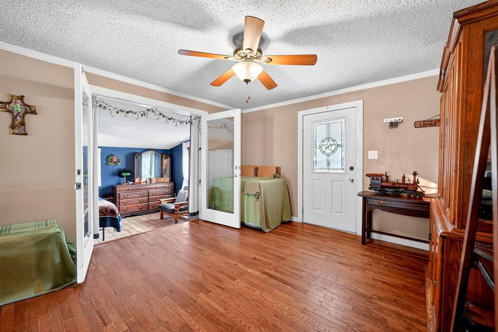 610 Crooked Creek Road Edgewood, TX 75117 - Photo 7 of 33 a living room with furniture and a wooden floor