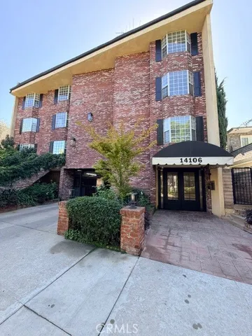 a front view of a building with garden