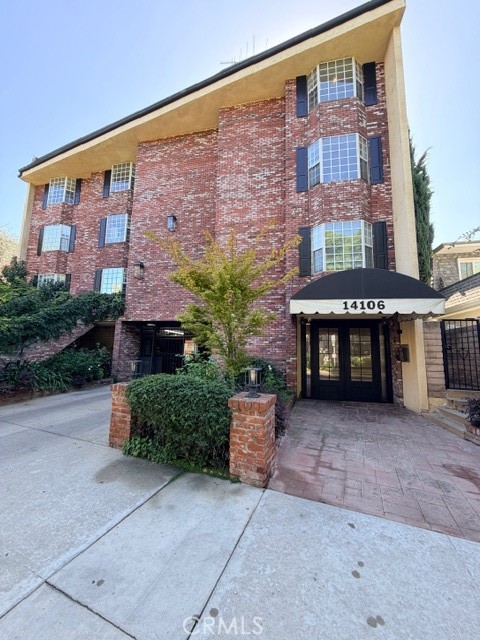 14106 Dickens Street, Unit 101 Sherman Oaks, CA 91423 - Photo 1 of 26 a front view of a building with garden