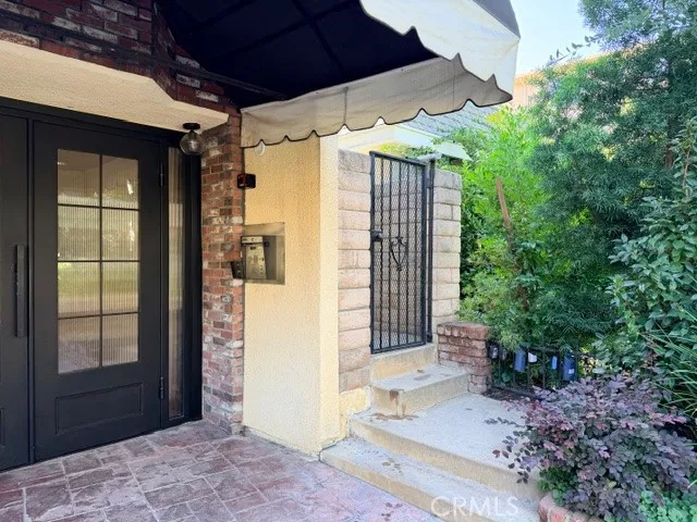 a view of a porch with a floor to ceiling window and a yard