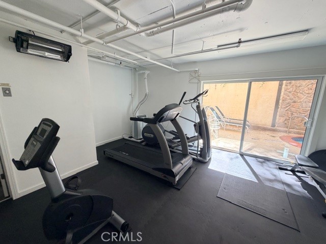 14106 Dickens Street, Unit 101 Sherman Oaks, CA 91423 - Photo 22 of 26 a room with gym equipment and a large window