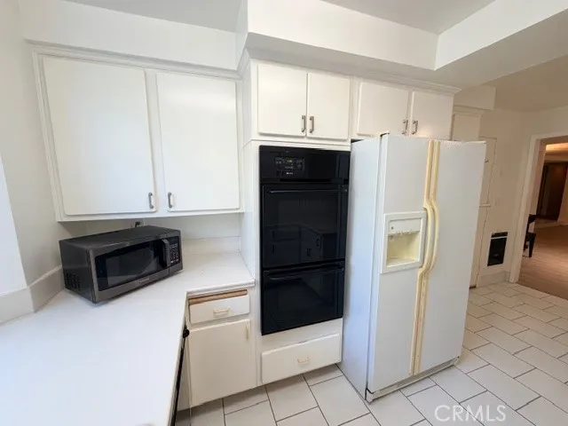 a kitchen with a sink a stove and cabinets