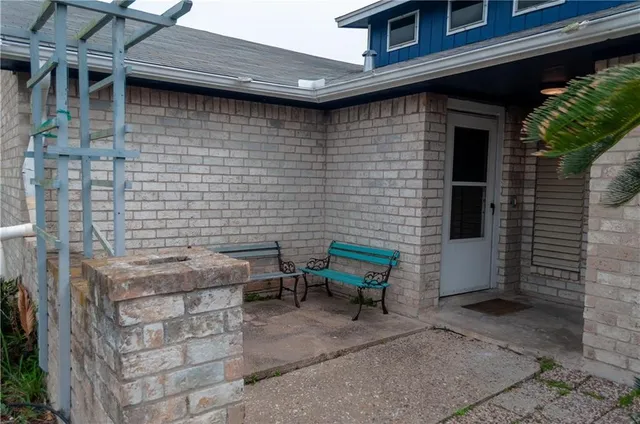 a brick building with a bench in front of it