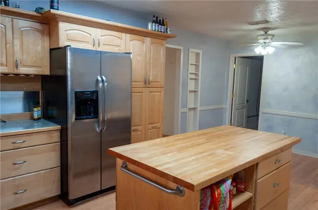 a kitchen with stainless steel appliances a refrigerator and a stove