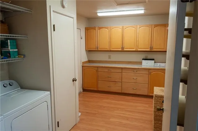 a view of a storage and utility room with washer and dryer
