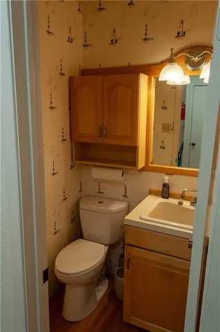 a bathroom with a toilet sink and mirror