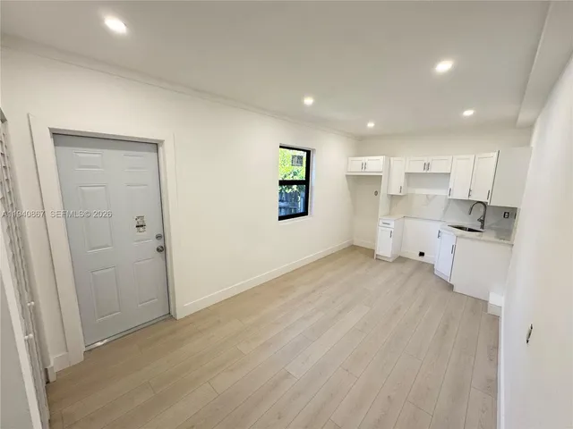 a view of a kitchen with wooden floor