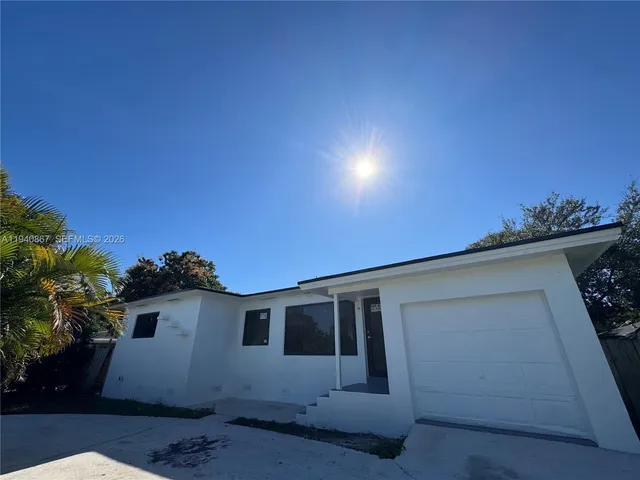 a house with trees in the background