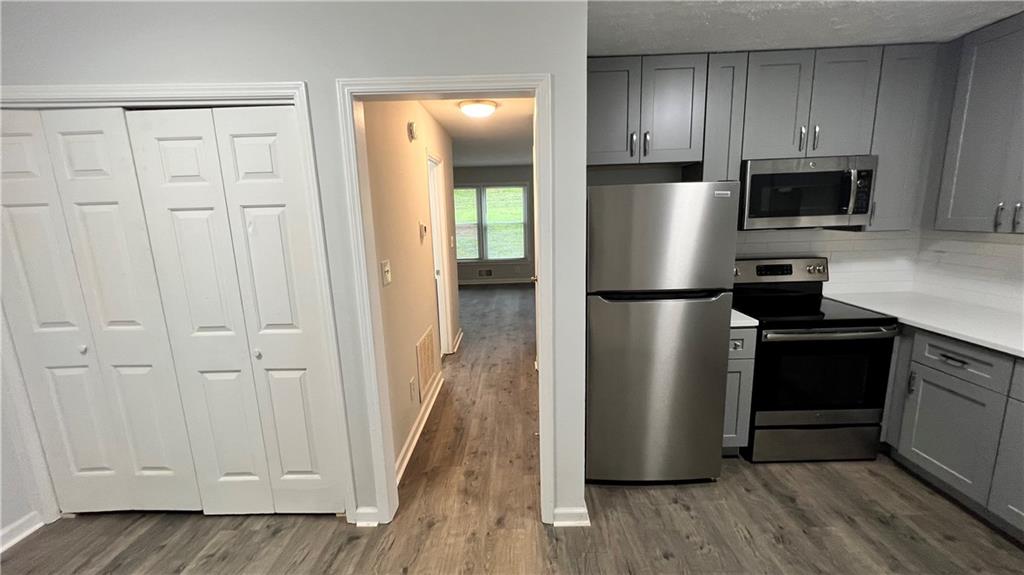 4007 Burns Road Northwest Lilburn, GA 30047 - Photo 11 of 20 a kitchen with a refrigerator cabinet and a microwave