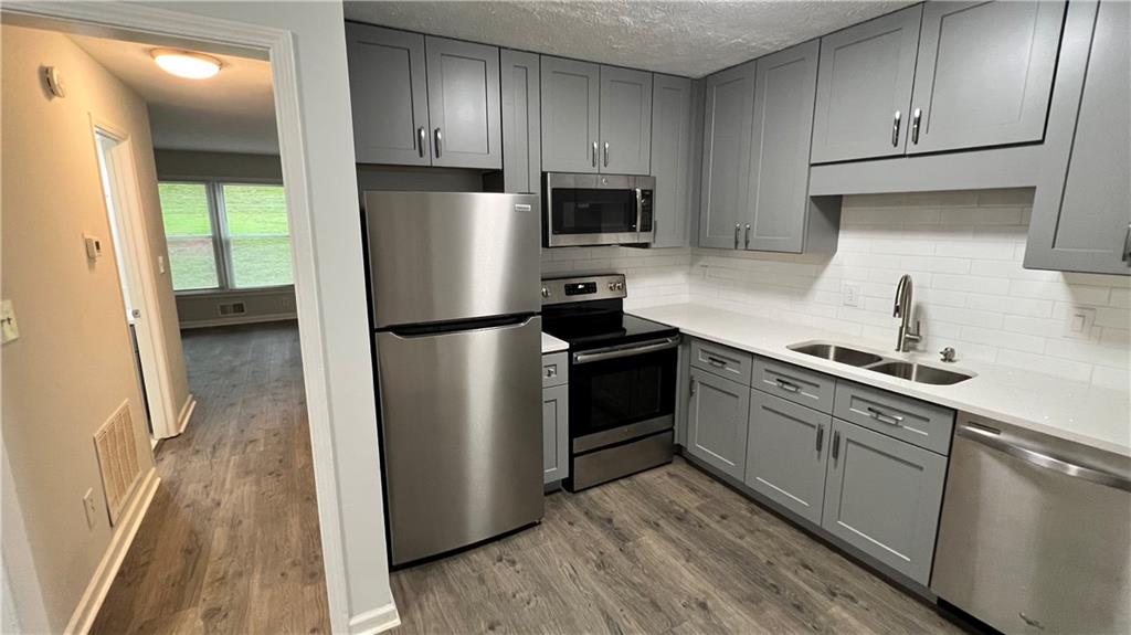 4007 Burns Road Northwest Lilburn, GA 30047 - Photo 12 of 20 a kitchen with a refrigerator sink and microwave