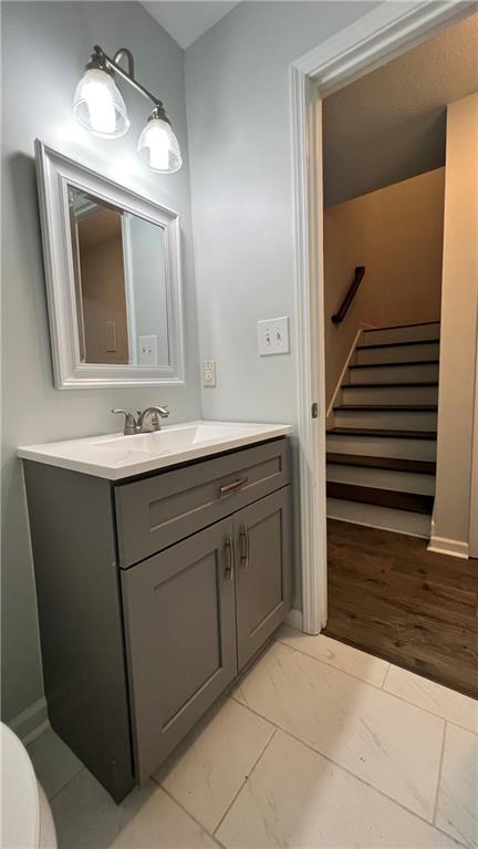 4007 Burns Road Northwest Lilburn, GA 30047 - Photo 13 of 20 a bathroom with a sink a mirror and a toilet