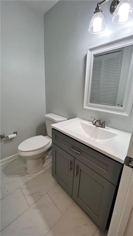 4007 Burns Road Northwest Lilburn, GA 30047 - Photo 14 of 20 a bathroom with a sink a toilet and a mirror