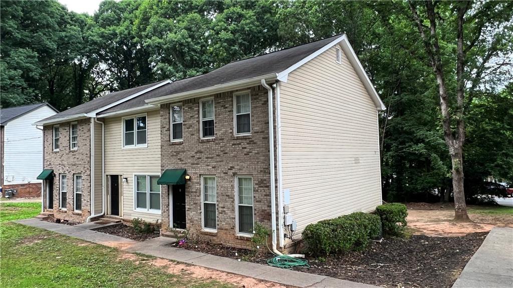 4007 Burns Road Northwest Lilburn, GA 30047 - Photo 2 of 20 a front view of a house with yard
