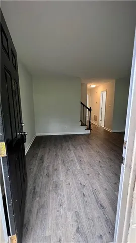 a view of a room with wooden floor and staircase